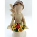 Willow Tree style wooden angel holding yellow and red flowers