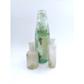 Three antique glass bottles