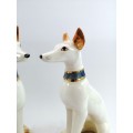 Pair of porcelain tall greyhound statues