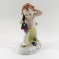 German Sitzendorf Figurine Depicting a Putto Carrying Grapes