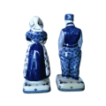 Pair of Delft Koninklijke white porcelain figurines with traditional costume decorations