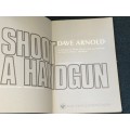SHOOT A HANDGUN BY DAVE ARNOLD