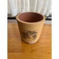 Used clay pot or potholder with small legs for inside or outside use