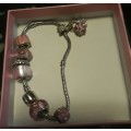Pandora styled bracelet in pink with extra blue charms in box