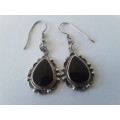 Solid sterling silver teardrop earrings with black stones. Possibly onyx