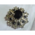 RAISED SLVER TONED BROOCH WITH BLACK STONED AND BLING