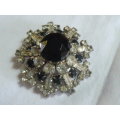 RAISED SLVER TONED BROOCH WITH BLACK STONED AND BLING