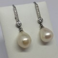 Pair of sterling silver pearl earrings with cubic zirconias - weighs 4.4g