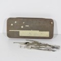 Vintage tin with technical drawing instrument parts