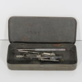 Vintage tin with technical drawing instrument parts