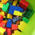 Large lot of assorted building blocks - Lego Duplo, Mega blocks, Playmobil - Plastic bin included