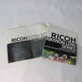 Ricoh KR-10 camera in pouch with Rikenon 1:2 50 mm lens and booklets