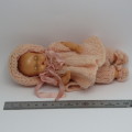 Small Tudor Rose plastic baby doll with closing eyes