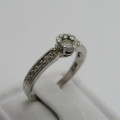 9kt White Gold diamond ring with 0.10ct diamond and smaller 0.15ct in total - weighs 2.2g - size L/6