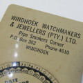 Windhoek watchmakers and jewelers - 1950 - 1975 date calendar - metal