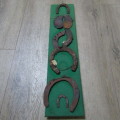 Board with antique horseshoes, some for oxen and ponies originating from South West Africa
