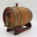 Vintage wooden wine barrel on stand with brass tap