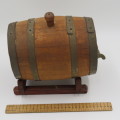 Vintage wooden wine barrel on stand with brass tap