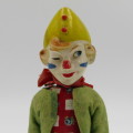Vintage mechanical clown toy that shakes when winded up