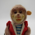 Vintage mechanical monkey toy that does back flips