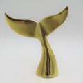 Gold coloured whale tail ornament