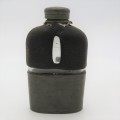 Antique leather clad glass hip flask with pewter lid and cup