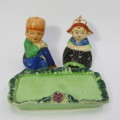 Pair of vintage Dutch boy and girl salt and pepper shakers on stand