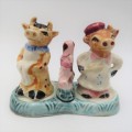 Vintage porcelain cow sale and pepper shakers on stand