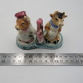 Vintage porcelain cow sale and pepper shakers on stand