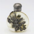 Vintage perfume bottle with silver-plated roses design