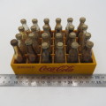 Vintage miniature Coca-Cola bottles in yellow tray - Two Coke bottles missing and was replaced