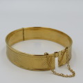 Beautiful gold bangle with safety chain - metal core