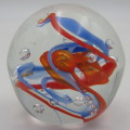 Handmade glass paperweight with bubbles and spiral design