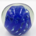 Vintage glass paperweight with blue design