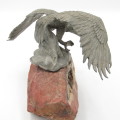 Beautiful white metal eagle sculpture on stone base