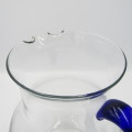 Vintage glass pitcher with blue handle