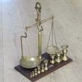 Antique brass balancing scale with set of bell weights