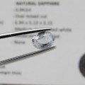 Natural Sapphire of 0,94 carat medium dark toned white - oval mixed cut with Gemlab certificate