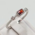 Sterling silver ring with a red stone and two clear stoned- size R 1.8g