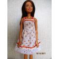 Barbie summer dress with orange trim.