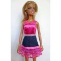 Barbie doll`s denim and pink ribbon dress