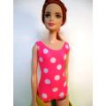 Barbie doll`s bathing costume and beach towel - pink spot
