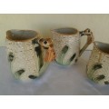 A set of three vintage bee style porcelain decorative porcelain jugs