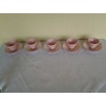 a lot of five pretty small pastel pink espresso coffee cups and saucers