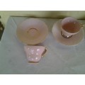 a lot of five pretty small pastel pink espresso coffee cups and saucers