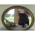 stunning round gold painted wall mirror with some slight damage noted