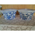 A pair of pretty blue and white floral and bird scene pot plant holders please note the listing
