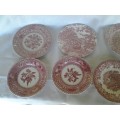 eight assorted pretty red and white porcelain side plates