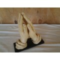 A nice vintage resin religious praying hands on base