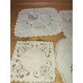 Four assorted tray cloths